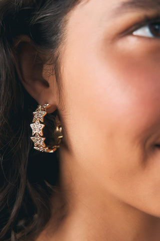 Lifestyle image of the Gold Star Hoop Earrings