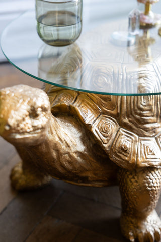 The Gold Tortoise Side Table showing the glass table top