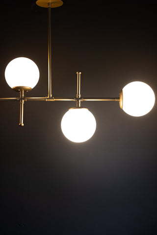 Lifestyle image of the Gold & White Glass Globe Ceiling Light.