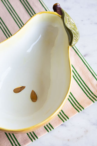 Close-up of the Golden Pear Snack/Serving Bowl on a striped tablecloth.