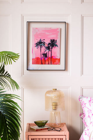 The HKLiving Pink Summer Framed Artwork on the wall above a bedside table, plant and bed.