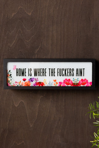 The Home Is Where The Fuckers Aint Light Box displayed on the wall.