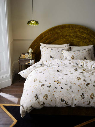 The Jane's Rose Duvet Cover and Pillow Case Set styled on a bed. There is also a bedside table, rug, light and various home accessories.