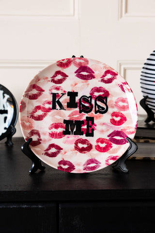 Image of the Kiss Me Decorative Wall Plate on a stand