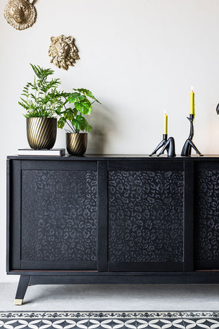 The Large Black Leopard Print Sideboard styled with plants and accessories.