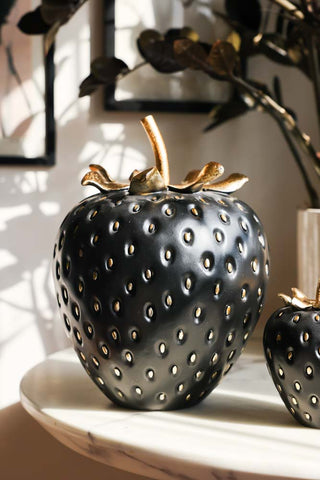 Lifestyle image of the Large Black & Gold Strawberry Ornament