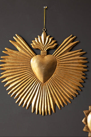 The Large Milagro Antiqued-Style Heart Decoration hanging on a black wall.