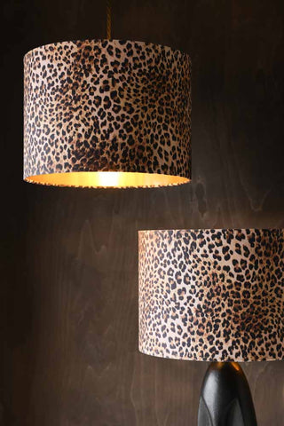 Image showing the Leopard Love Drum Lamp Shade on a table lamp and hanging as a pendant light with the light switched on.