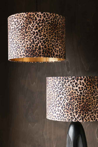 Image showing the Leopard Love Drum Lamp Shade on a table lamp and hanging as a pendant light with a wood backdrop.