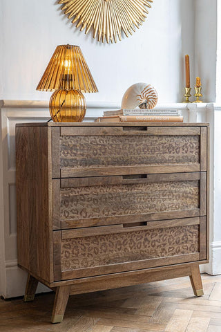 The Leopard Print Chest of Drawers styled with a lamp and various accessories on.