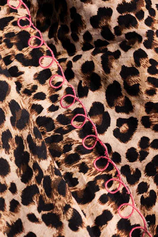 Detail shot of the edge of the Leopard Print Scalloped Edge Quilt.