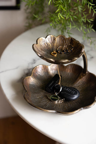 Lifestyle image of the Lily Pad Display Double Dish displayed on a marble table, with jewellery and keys inside. There is a plant and art print in the background.