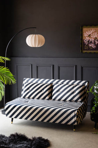 Lifestyle image of the Mabel Large 2 Seater Sofa Bed in Studio Stripe Velvet Sand & Black