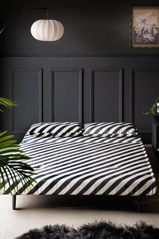 Image of the Mabel Large 2 Seater Sofa Bed in Studio Stripe Velvet Sand & Black as a bed