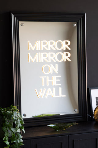 The Mirror, Mirror...Framed Neon Wall Light and mirrored wall art with a black frame styled on a sideboard.