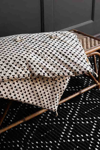 Image of the Monochrome Heart End Of Bed Throw on a bench
