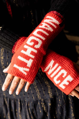 Naughty or Nice Handwarmers being worn by a model in dark clothing.