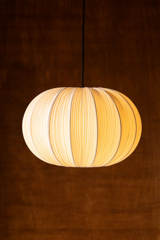 Lifestyle image of the Neutral Pleated Fabric Ceiling Light with light switched on