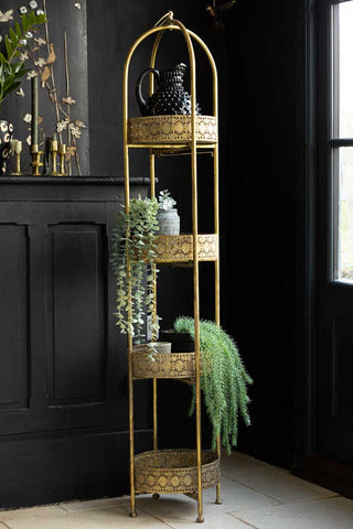 Lifestyle image of Ornate Gold Tall Tray Shelves styled with various other home accessories.