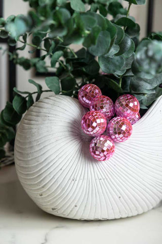 Pink disco fairy lights in a white shell planter