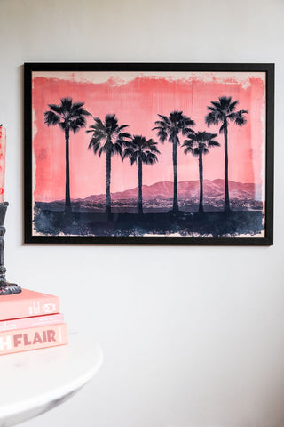 Lifestyle image of Pink Sunset A2 Art Print in a black frame on a light background.
