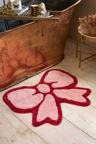 Lifestyle image of the Pink & Red Bow Shape Rug