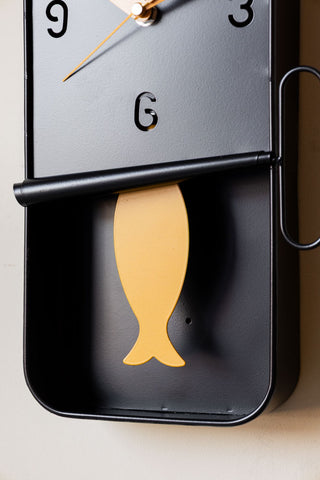 Close-up of the Quirky Sardine Tin Pendulum Wall Clock.