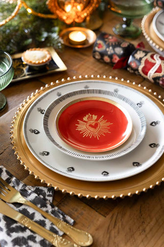 Lifestyle image of the Red & Gold Milagro Heart Decorative Wall Plate