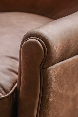 Close-up of the end of the arm of the Rich Brown Vintage-Style Leather Armchair.