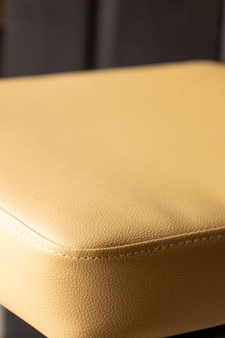 Close-up image of the Sand Faux Leather Roll Back Bar Stool
