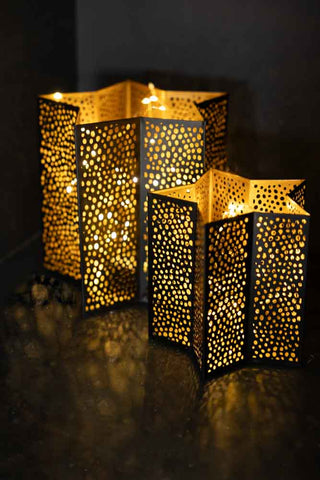 Lifestyle image of the Set Of 2 Black & Gold Star Lanterns