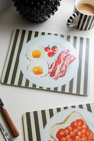 Set Of 2 Breakfast Placemats displayed on a table with a mug, cutlery and a jug.