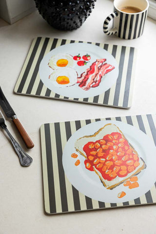 Set Of 2 Breakfast Placemats displayed with a mug, cutlery and a jug.