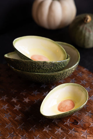 A Lifestyle image of the Set Of 4 Avocado Nesting Bowls styled on a star serving board