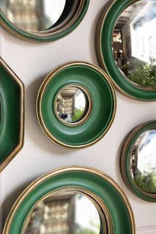Close-up of some of the Set of 12 Antique Green & Gold Convex mirror set displayed on the wall.