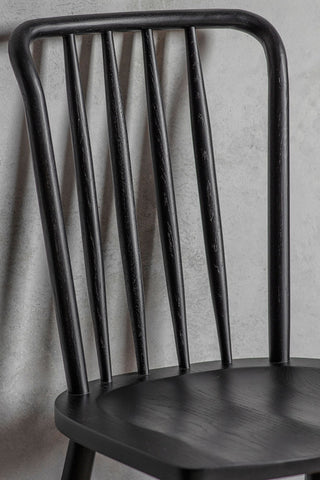 Close-up of the top of one of the Set of 2 Classic Wooden Frame Dining Chairs in front of a plain wall.