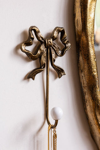 Lifestyle image of the Set of 2 Pretty Gold Bow Wall Hooks