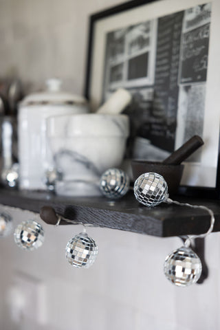 Silver disco ball fairy lights on a shelf