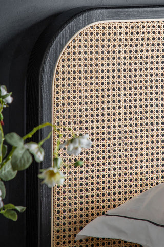 Close-up of the headboard of the Sleek Curved Wooden Bedframe.