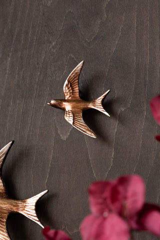 Lifestyle image of the Small Antiqued Copper Swallow Wall Decoration