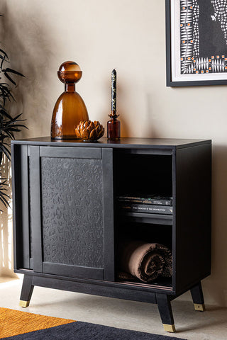 The Small Black Leopard Print Sideboard with the door open and some items inside, styled with various accessories on.