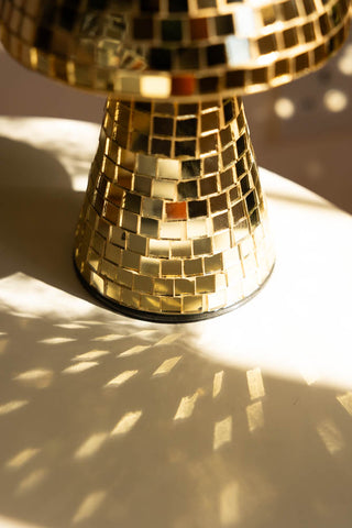 Detail image of the Small Disco Mushroom Ornament displayed on a table in the sunshine.