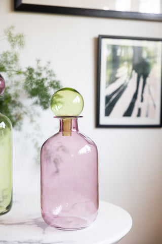 A styled image of the Pink & Green Apothecary Bottle on a white marble table.