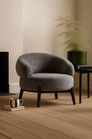 The Beautiful Curved Grey Accent Armchair styled in a corner.