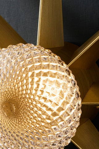 Detail image of the illuminated Gold Starburst Wall Light