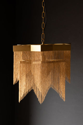 The Stunning Star Chain Chandelier hanging in front of a black background.