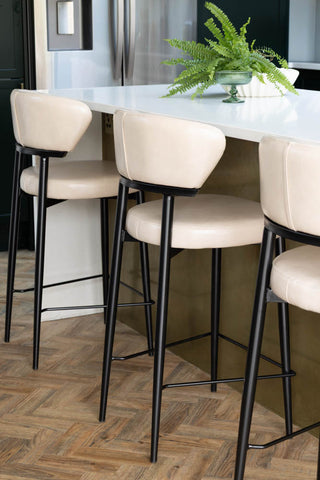 Three Blake Bar Stools In Champagne Neutral at a kitchen island.