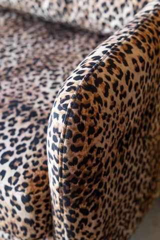 A close up image of an arm of the The Edie Leopard Print 2 Seater Sofa.