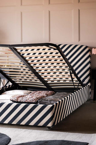 The Jagger Ottoman Bed in Studio Stripe Velvet Sand & Black with the ottoman open.