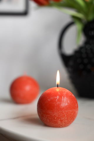Lifestyle image of the Unique Ball Candle In Rust Orange